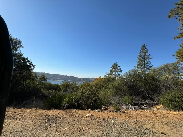 an aerial view of house with yard and mountain view in back
