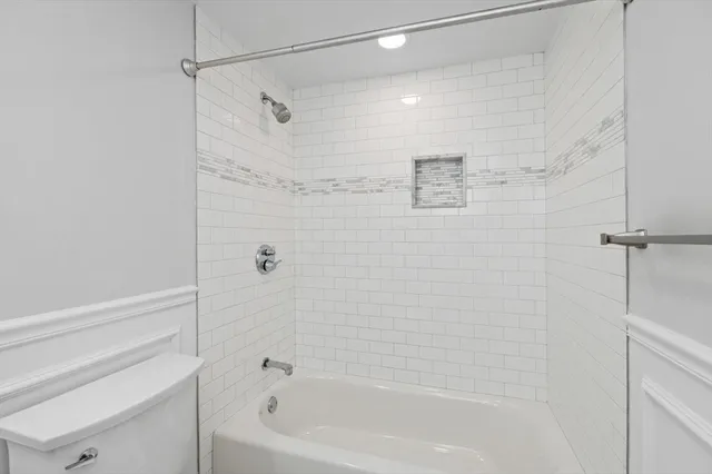 a bathroom with a shower and a bath tub