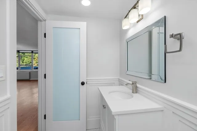 a en suite bathroom with a sink double vanity and a mirror