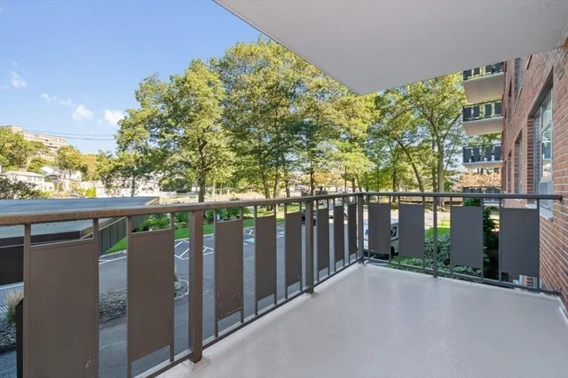 a balcony with trees in front of it