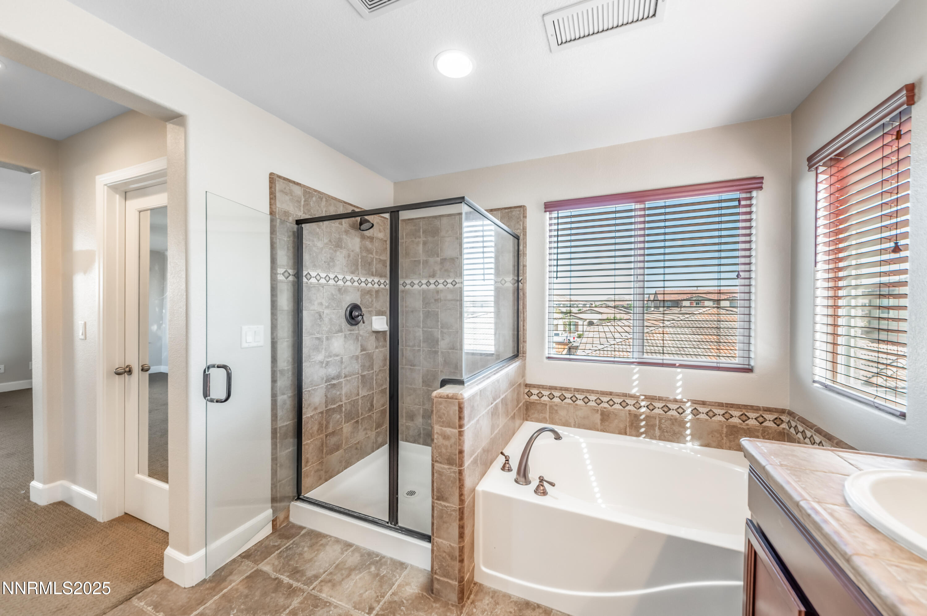1935 Glacier Meadow Drive Reno, NV 89521 - Photo 14 of 20 a bathroom with a large tub a shower and view