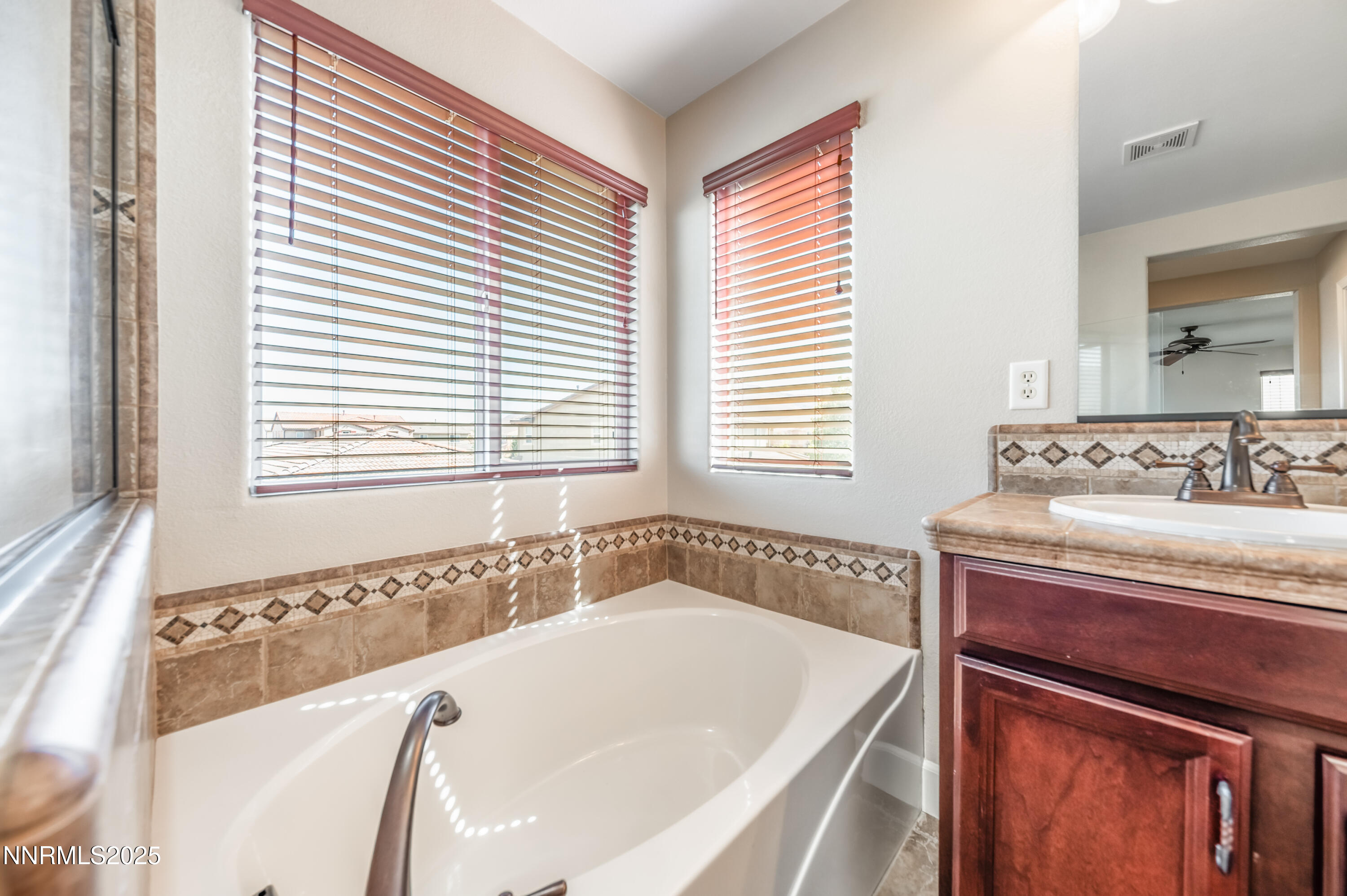 1935 Glacier Meadow Drive Reno, NV 89521 - Photo 15 of 20 a bath tub sitting in a bathroom next to a window
