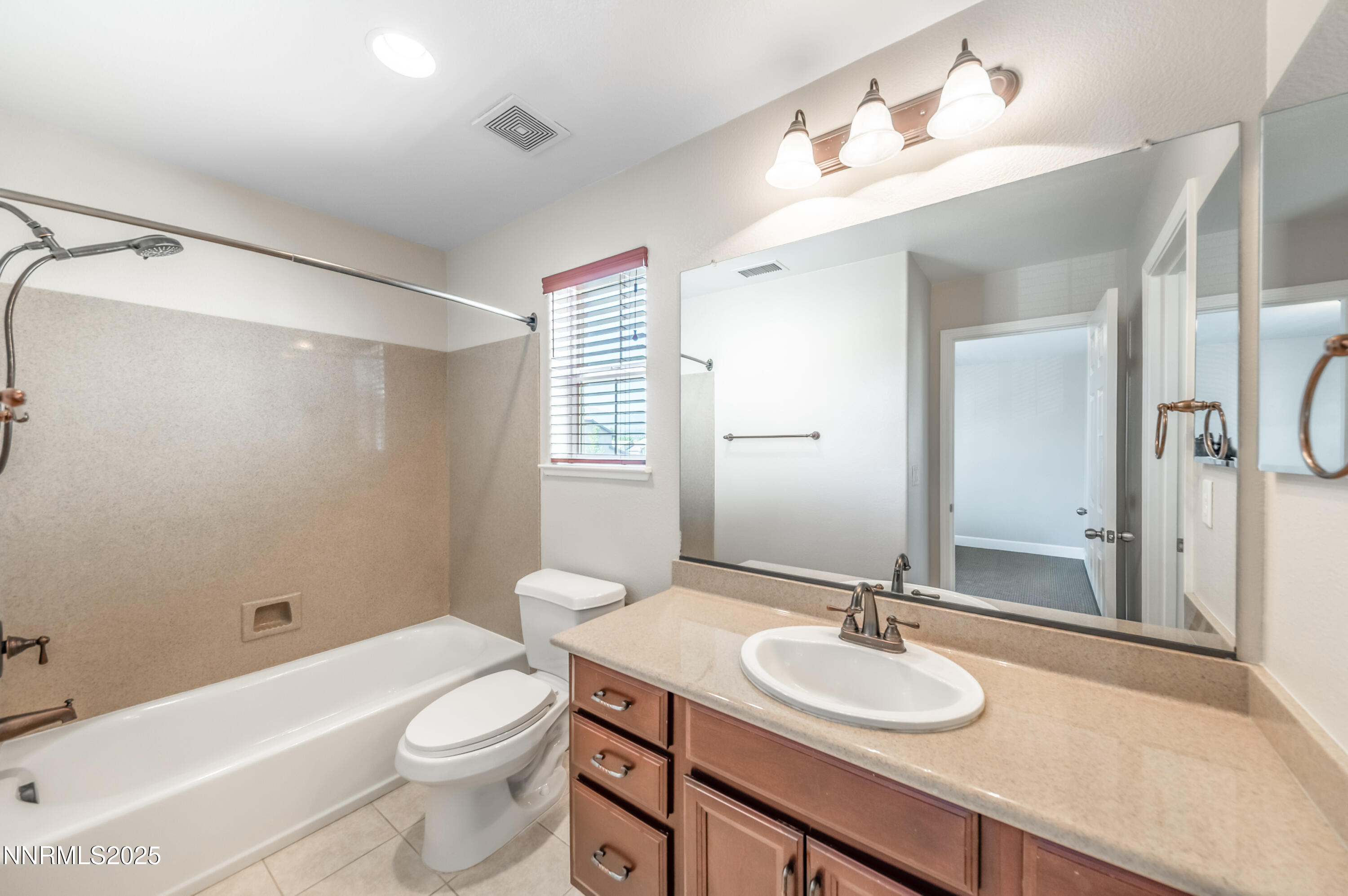 1935 Glacier Meadow Drive Reno, NV 89521 - Photo 17 of 20 a bathroom with a granite countertop sink toilet a large mirror and shower