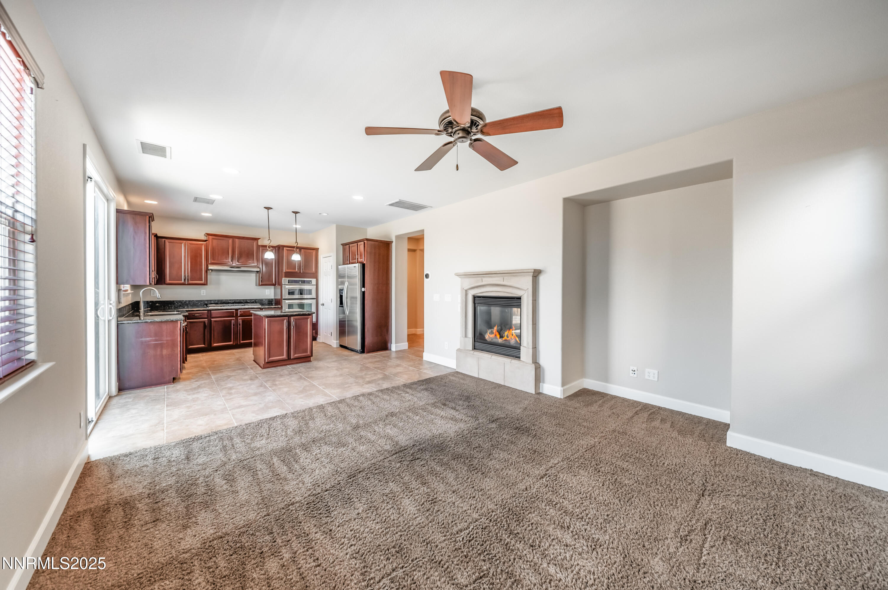 1935 Glacier Meadow Drive Reno, NV 89521 - Photo 8 of 20 an empty room with kitchen and fireplace