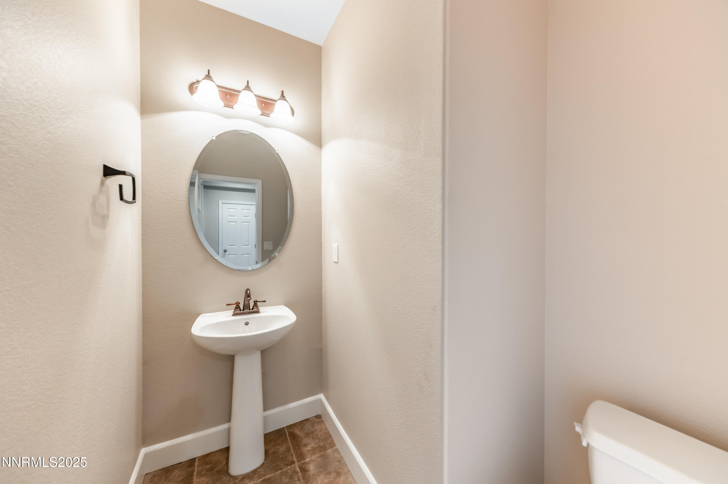 1935 Glacier Meadow Drive Reno, NV 89521 - Photo 10 of 20 a bathroom with a sink toilet and a mirror