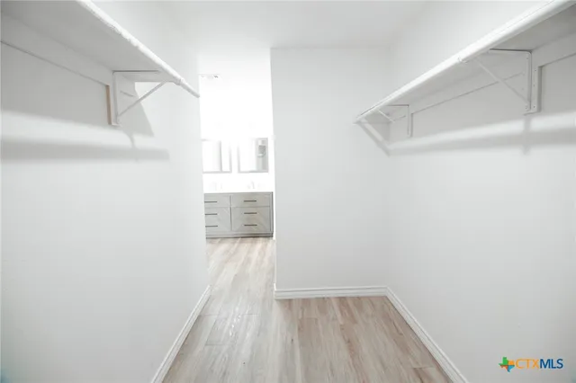 a view of hallway with wooden floor