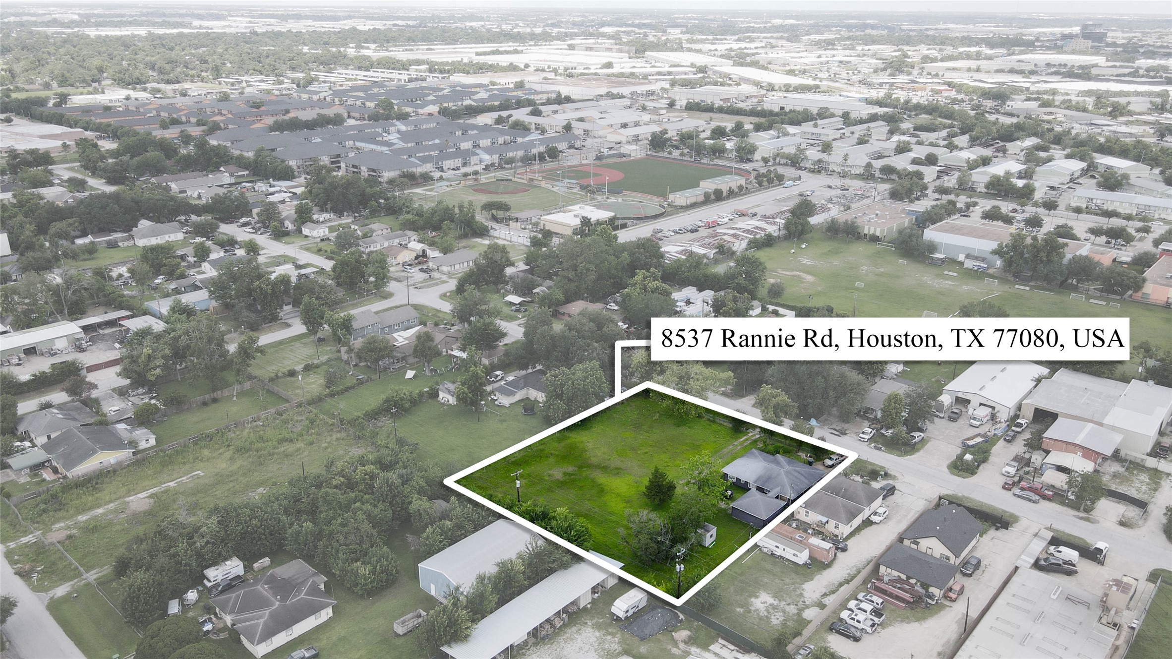 8537 Rannie Road Houston, TX 77080 - Photo 1 of 15 Aerial boundary view showcasing the three-parcel lot at 8537 Rannie Road and the rare scale of the land within Spring Branch. The outlined parcel highlights the depth, width, and open usable space, with nearby commercial buildings, parking areas, athletic fields, and residential streets reinforcing the property’s potential utility for builders, investors, parking, storage, future development, or commercial-adjacent use, subject to buyer verification.