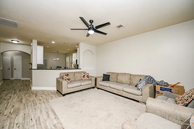 a living room with furniture and kitchen view