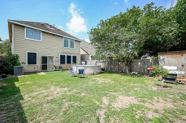 a view of a house with a backyard