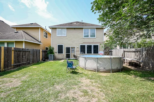a view of a house with a yard and a porch