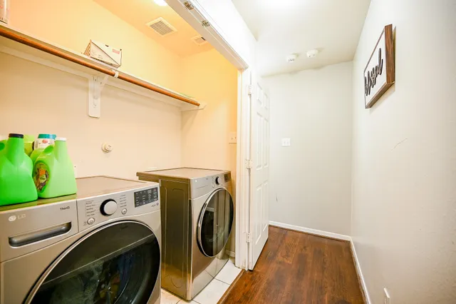a view of a hallway with washer and dryer