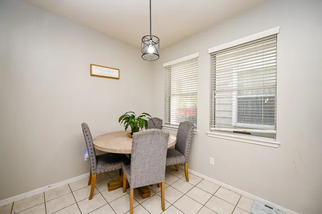 a dining room with furniture and window
