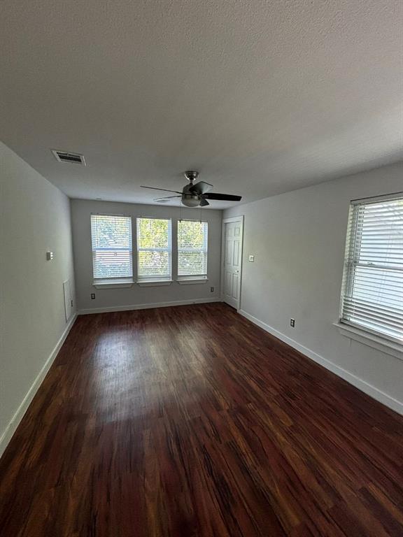 2505 May Street Fort Worth, TX 76110 - Photo 12 of 19 an empty room with wooden floor and windows