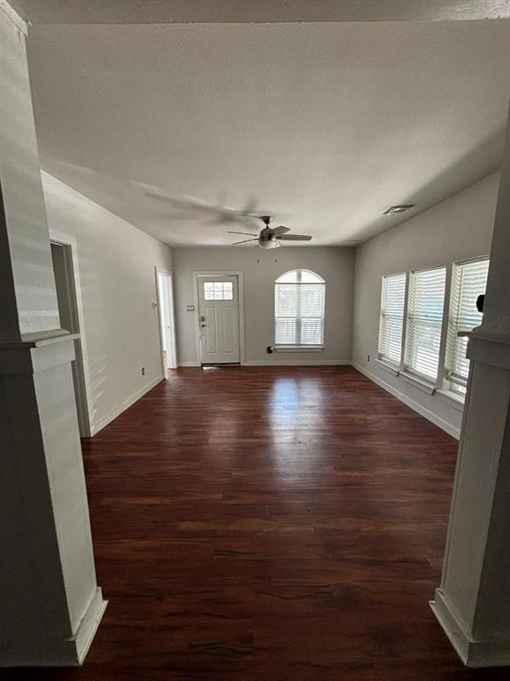 2505 May Street Fort Worth, TX 76110 - Photo 4 of 19 an empty room with wooden floor and windows