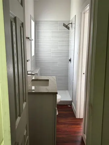 a bathroom with a double vanity sink a mirror and a bathtub