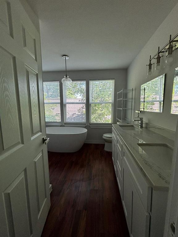 2505 May Street Fort Worth, TX 76110 - Photo 6 of 19 a bathroom with a double vanity sink a mirror and a bathtub
