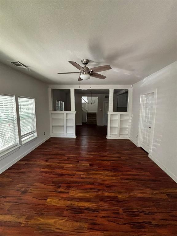 2505 May Street Fort Worth, TX 76110 - Photo 7 of 19 a view of empty room with wooden floor and fan