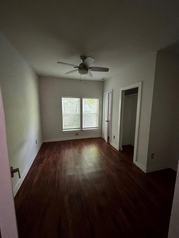 2505 May Street Fort Worth, TX 76110 - Photo 9 of 19 an empty room with wooden floor and windows