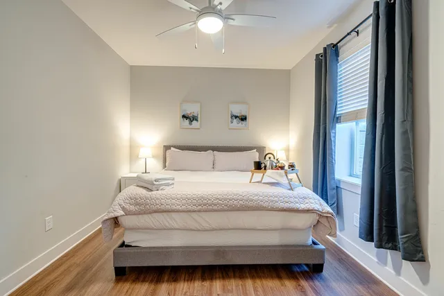 a bedroom with a bed and a window