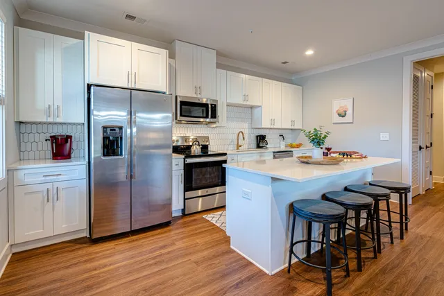 a kitchen with stainless steel appliances a refrigerator stove microwave and cabinets