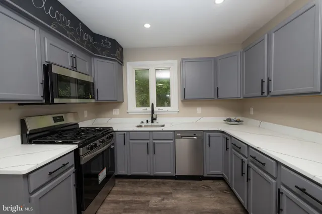 a kitchen with a sink stove and microwave