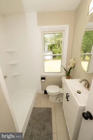 a bathroom with a sink a toilet and tub