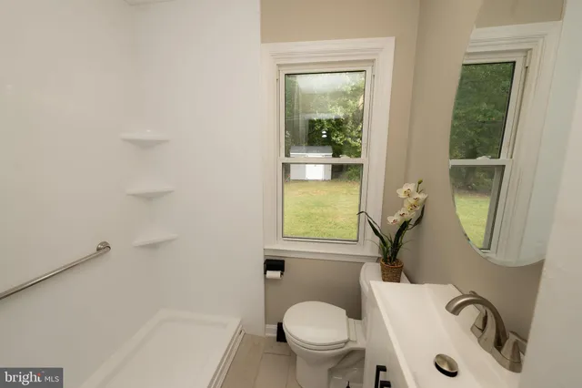 a white toilet sitting next to a bathroom sink