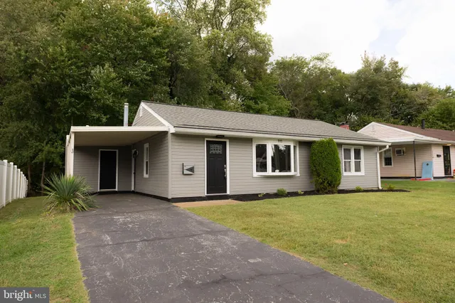 a front view of house with yard and trees