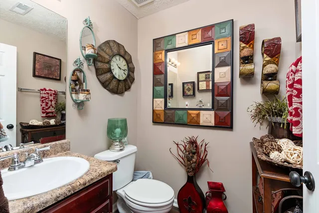 a bathroom with a toilet a sink and a mirror
