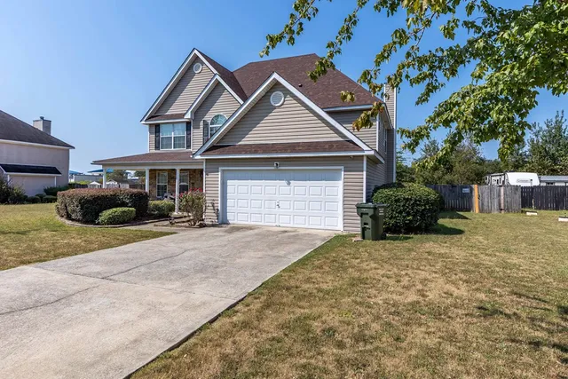 a front view of a house with a yard and garage