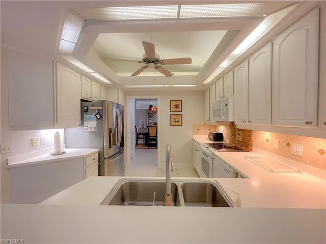 a kitchen with a sink cabinets and window
