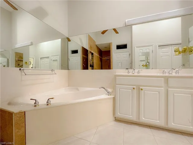 a bathroom with a double vanity sink mirror and