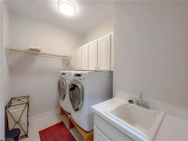 a utility room with sink dryer and washer