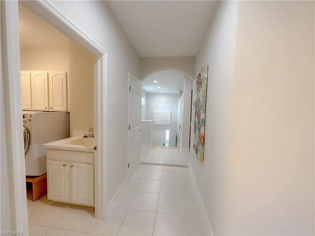 a bathroom with a sink and mirror with toilet