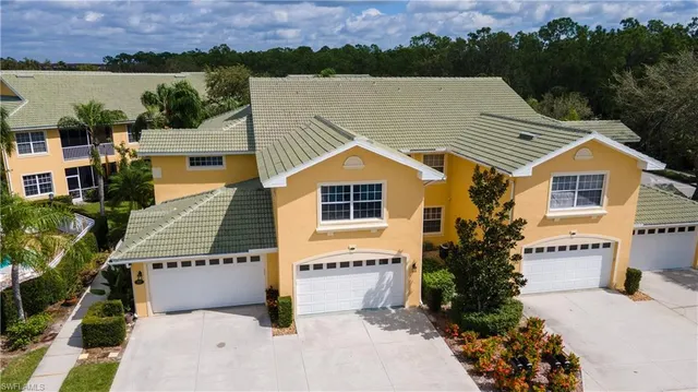 an aerial view of a house with a yard and a large pool