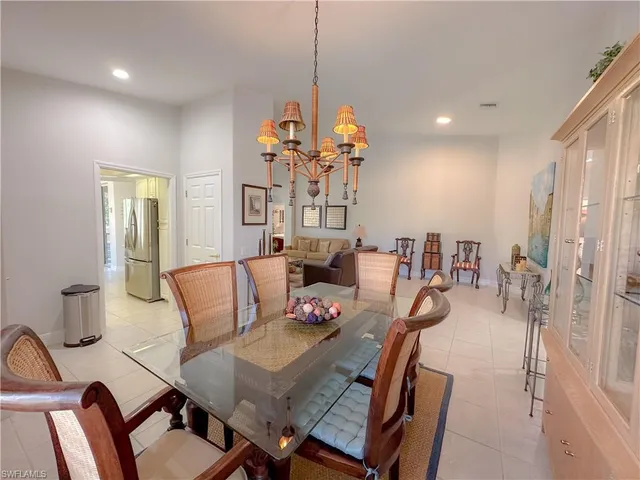 a view of a dining room with furniture and a chandelier