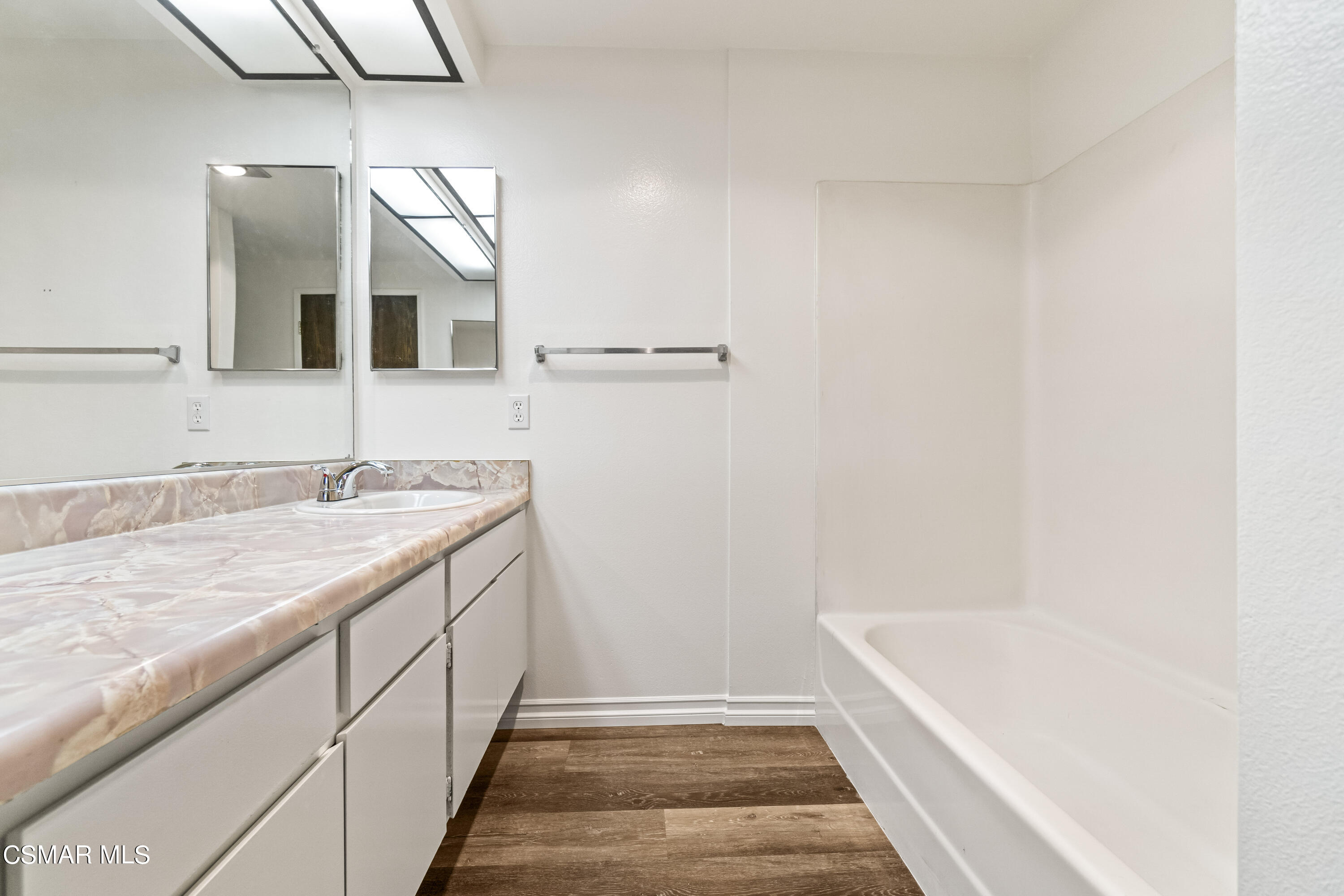 5133 Perkins Road Oxnard, CA 93033 - Photo 21 of 30 a bathroom with a granite countertop sink and a bathtub