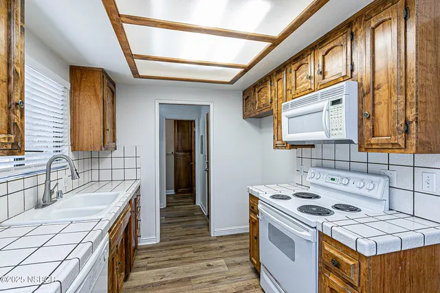 a kitchen that has a sink and a stove