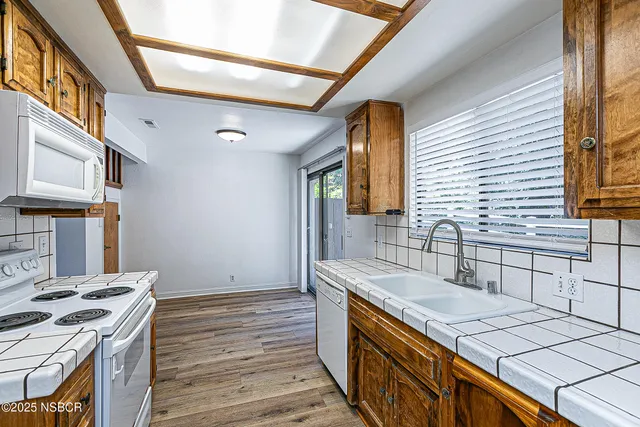 a kitchen with a sink stove and cabinets
