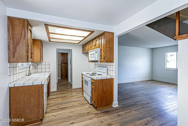 a view of a kitchen cabinets and a wooden floor