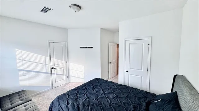 a bedroom with a bed and a chair