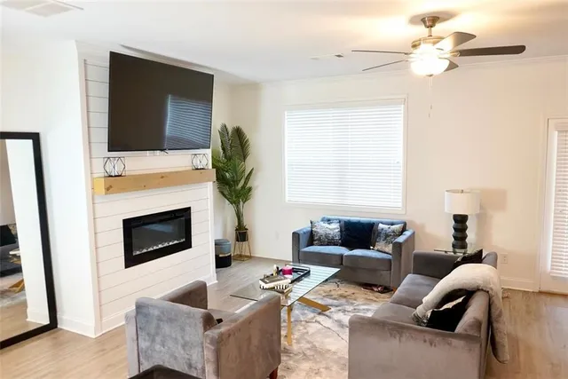 a living room with furniture a fireplace and a flat screen tv