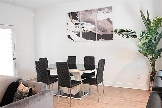 a dining room with furniture and wooden floor