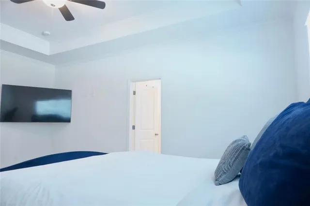 a bedroom with a bed and a flat screen tv