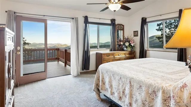 a spacious bedroom with a large bed and a chandelier