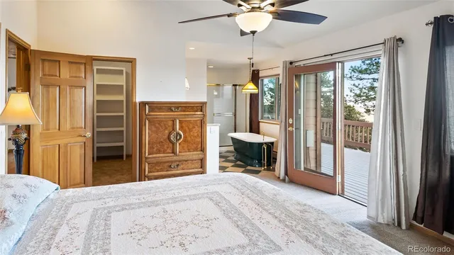 a bed room with a bed and a flat tv screen
