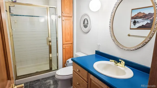 a bathroom with a sink mirror and toilet