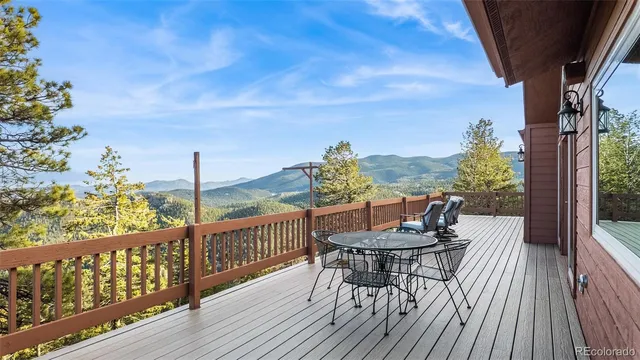a view of a balcony with furniture and wooden floor