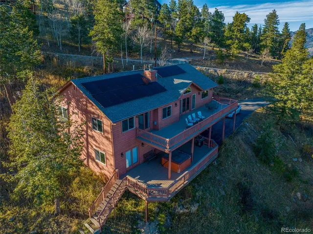a view of a house with a yard deck and a garden