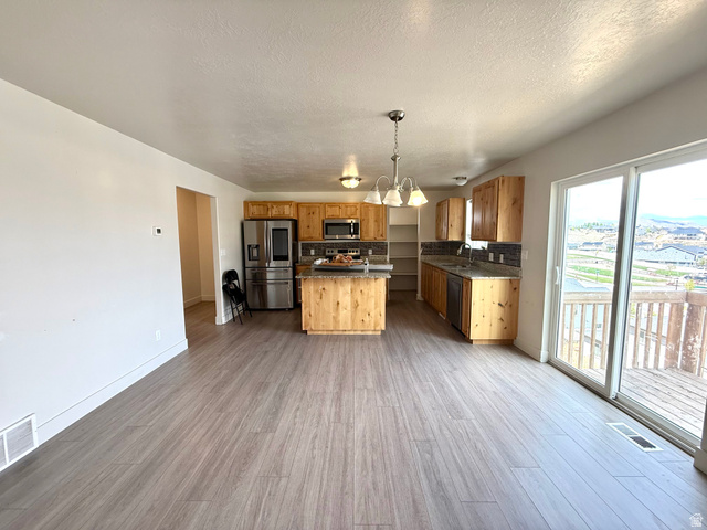 1823 South Longview Road Santaquin, UT 84655 - Photo 16 of 69 Open-concept living area with wood-finish flooring extending into the kitchen